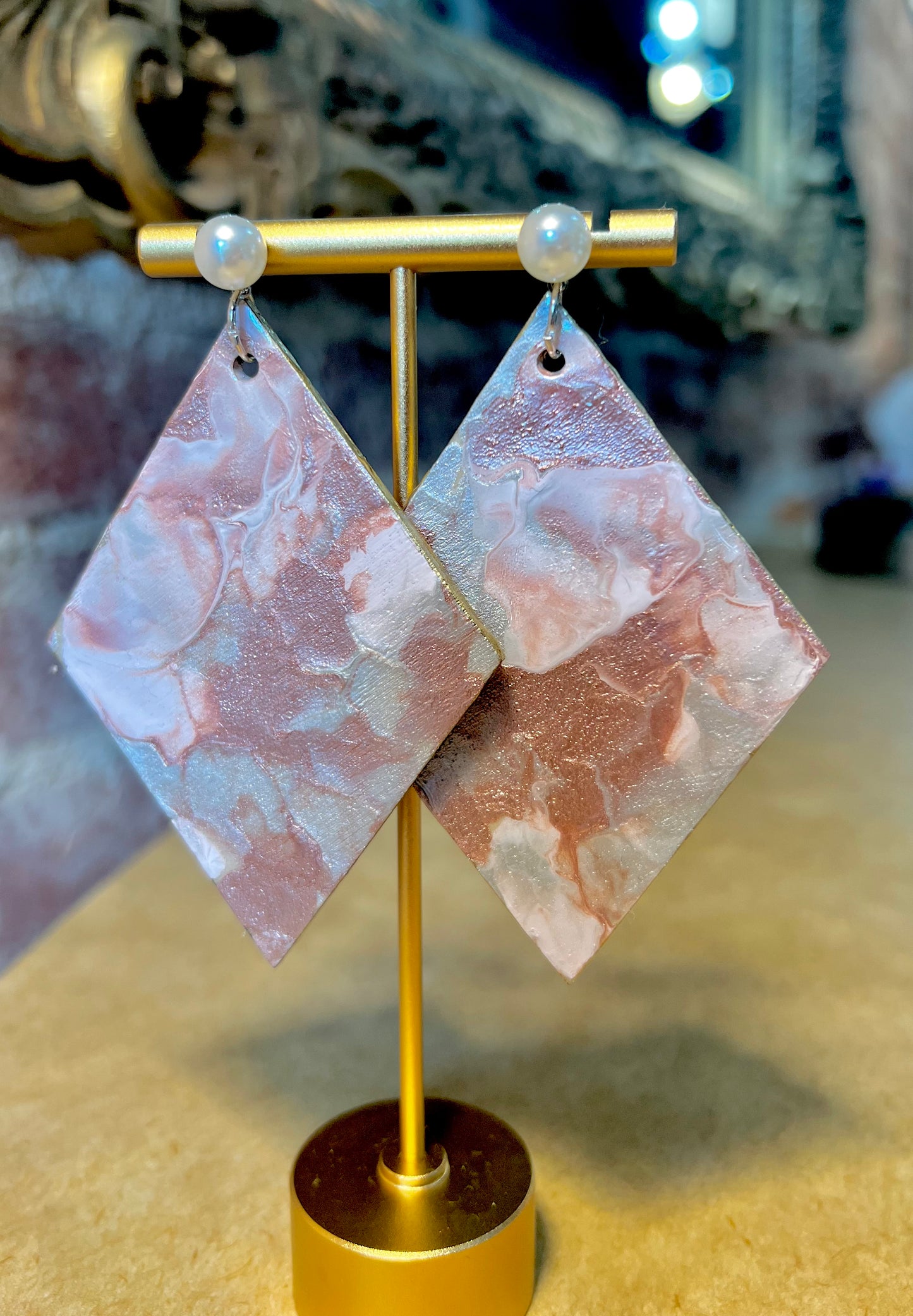 Diamond fluid art with hues of pink, white and gray.