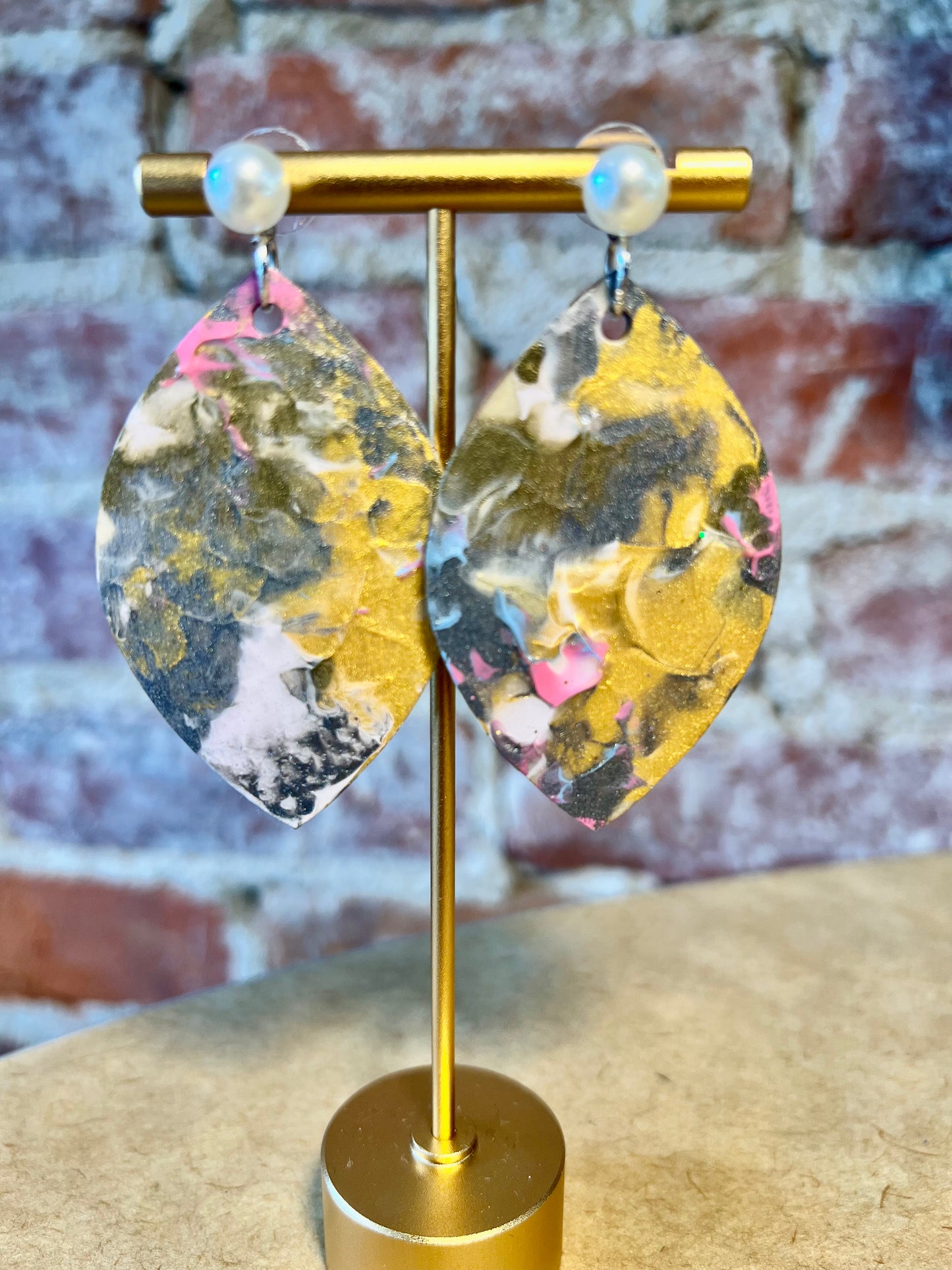 Multicolor fluid art with hues of green yellow, pink and white.