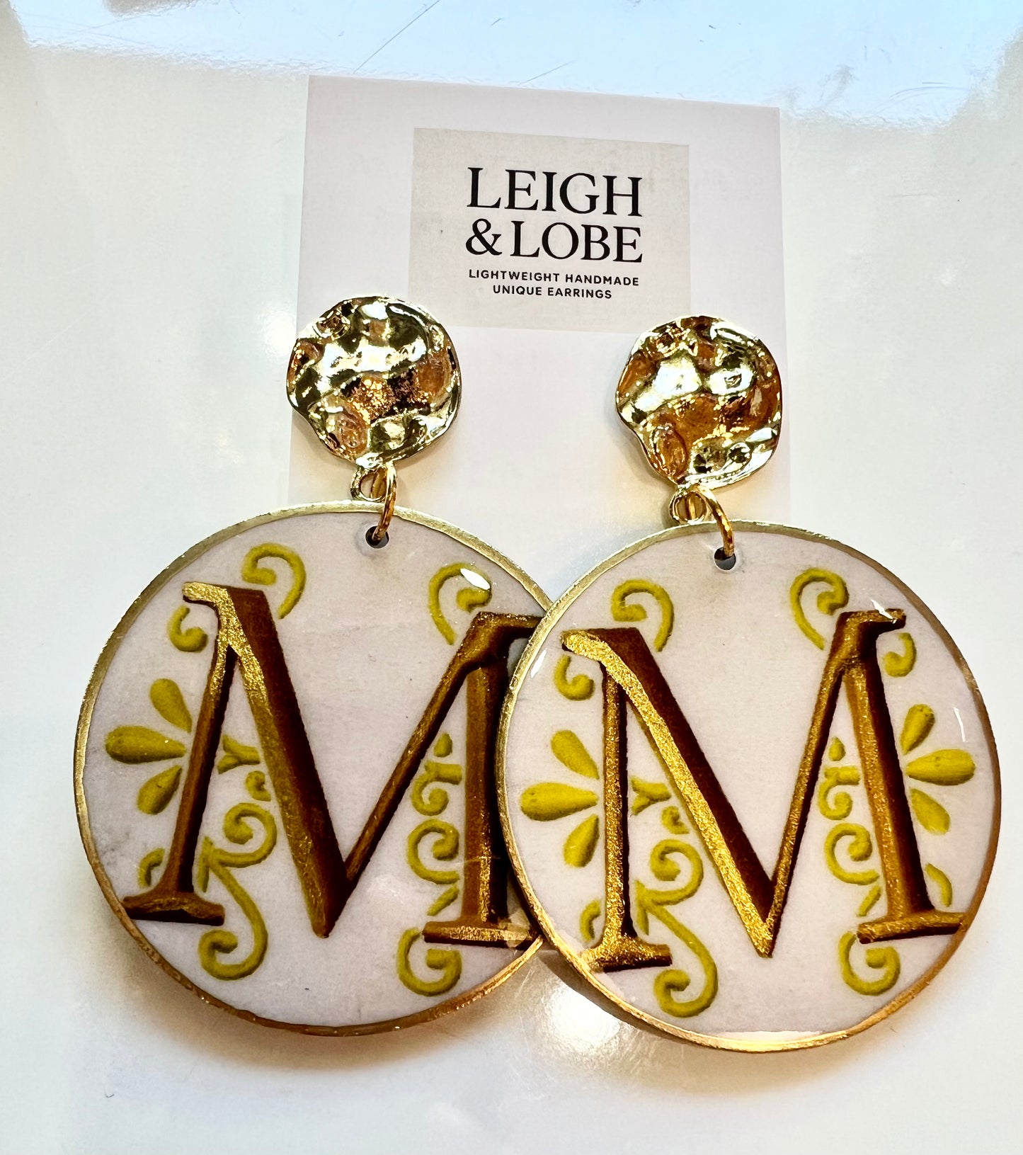 “M” monogram with gold hardware.